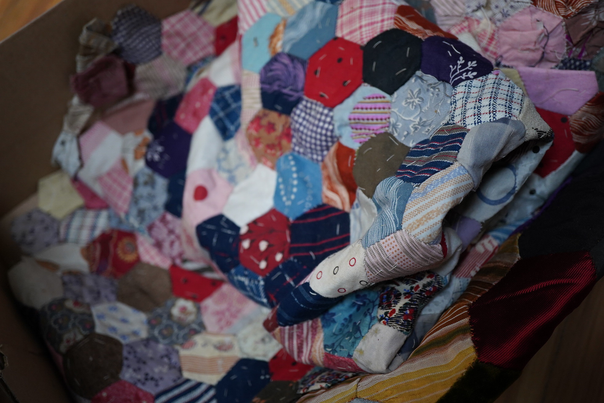 Three various sized 19th century patchwork panels and two patch worked cushions, for using as restoration fabric for larger damaged quilts.